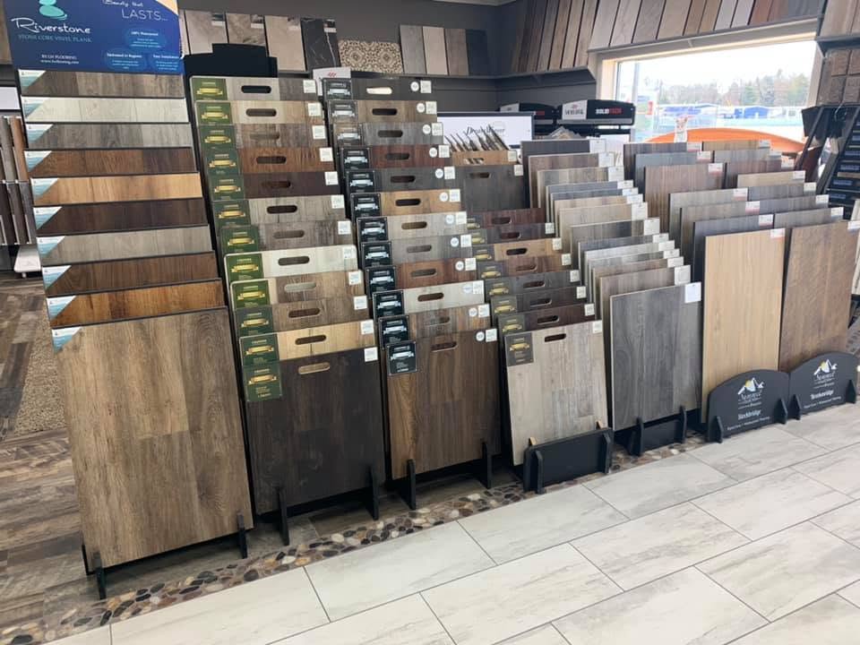 Wood-look vinyl and laminate plank samples on display inside the Canton Carpets showroom in Wills Point, Texas